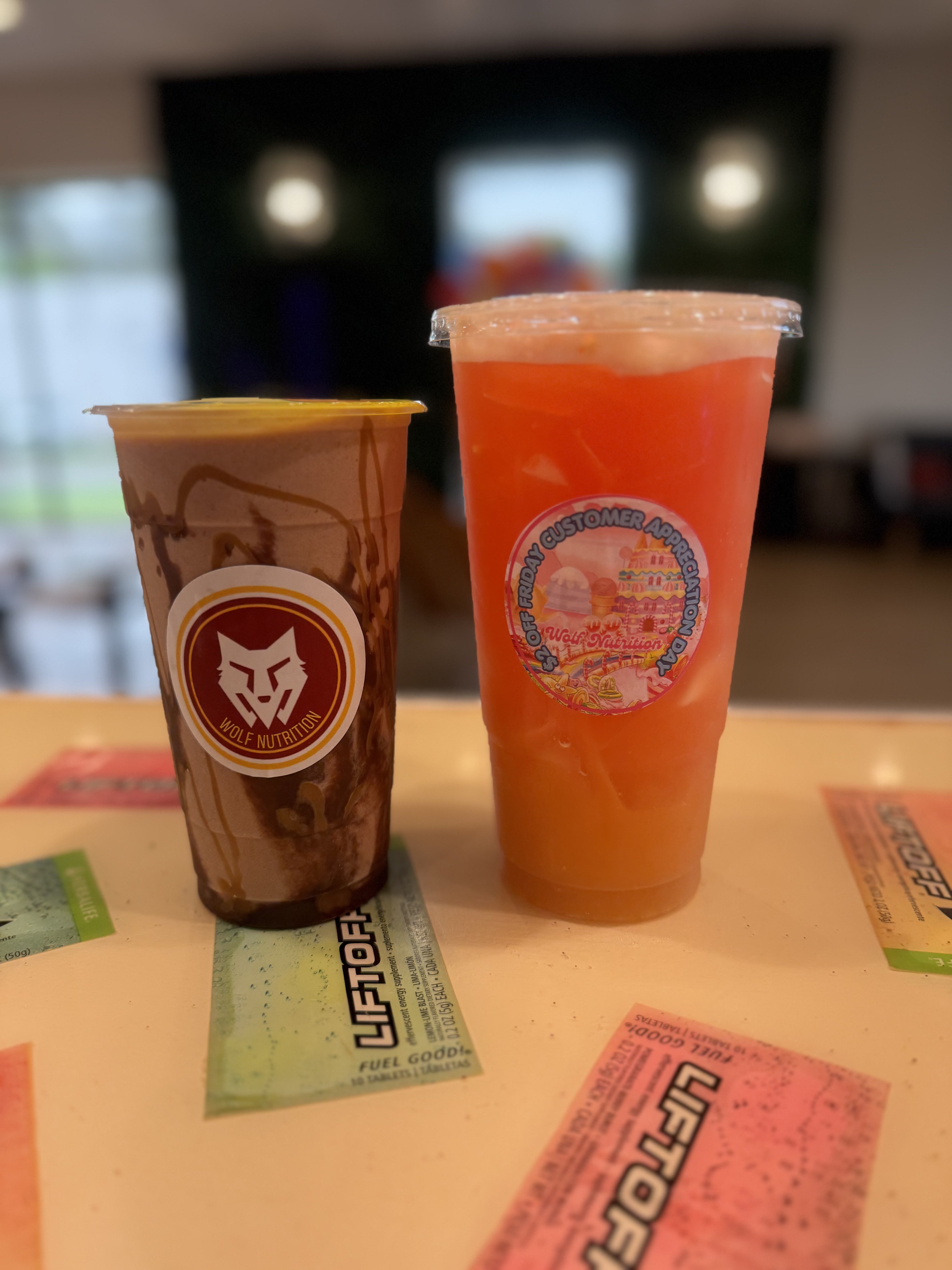 Wolf Nutrition chocolate shake and orange tea on the counter