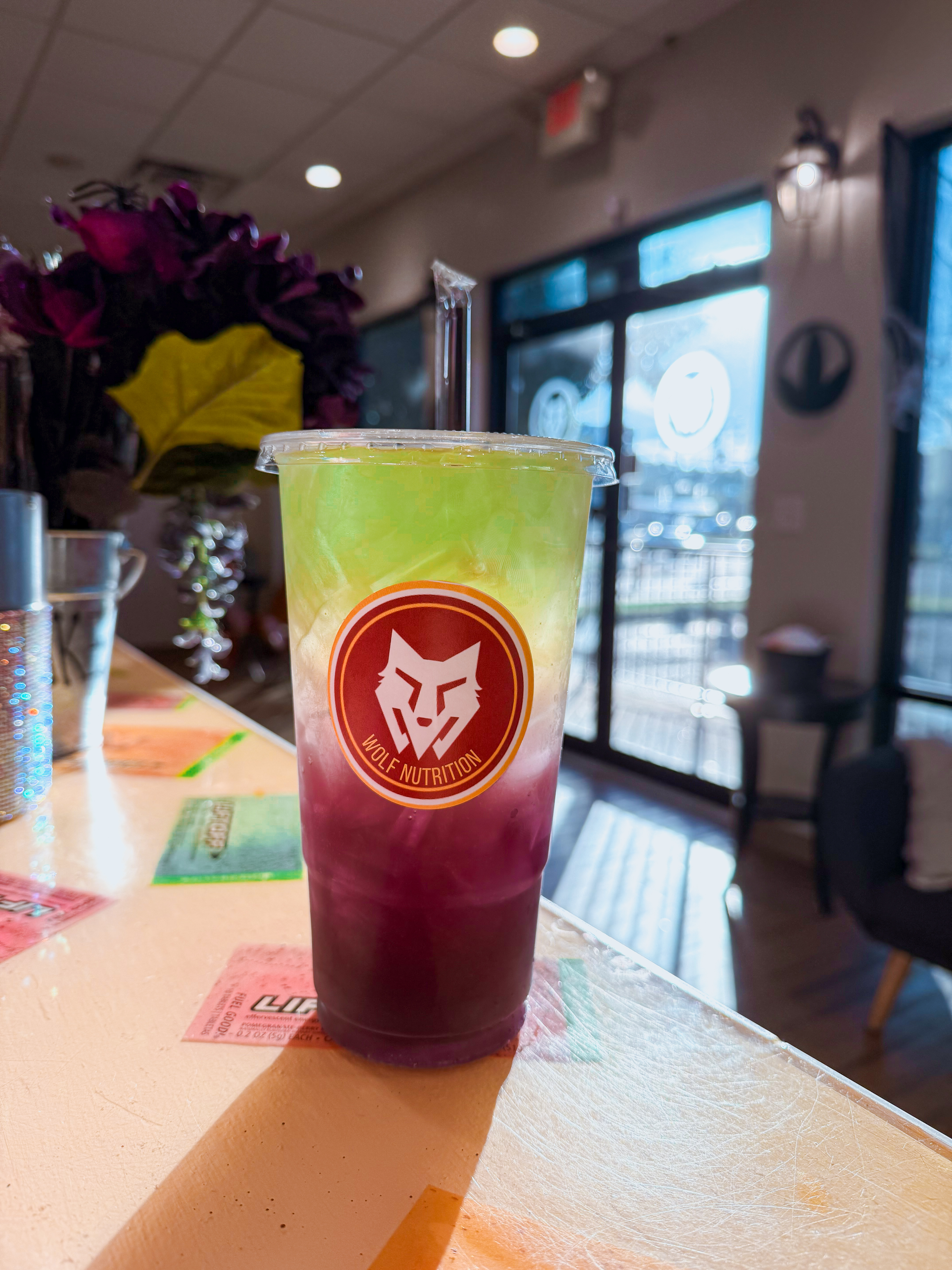 Green and purple layered energy tea at Wolf Nutrition